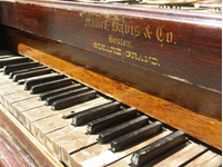 An old upright piano with worn keys